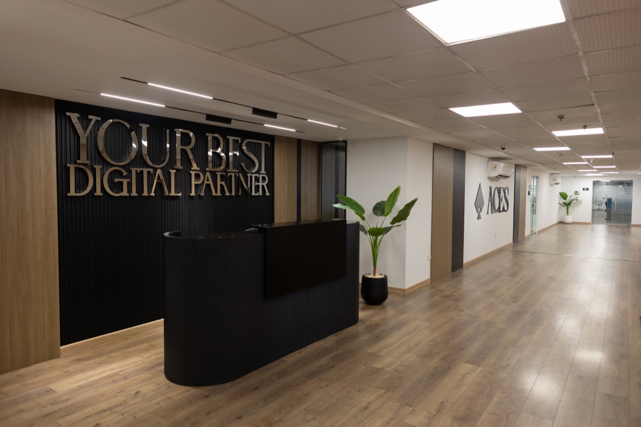 ACES reception with ‘Your Best Digital Partner’ signage and spade logo