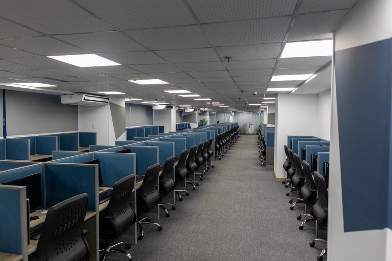 ACES agent workstations with blue partitions across the delivery floor